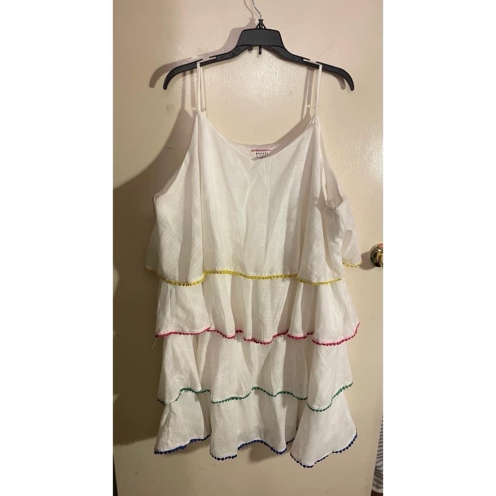 White linen style dress with layers and multi colored trim.